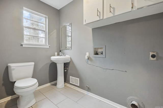 bathroom with sink, tile patterned flooring, and toilet