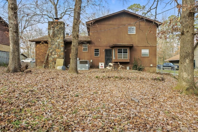 back of house featuring cooling unit