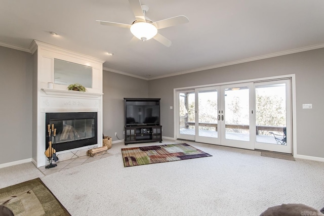 carpeted living room featuring plenty of natural light, a large fireplace, crown molding, and french doors