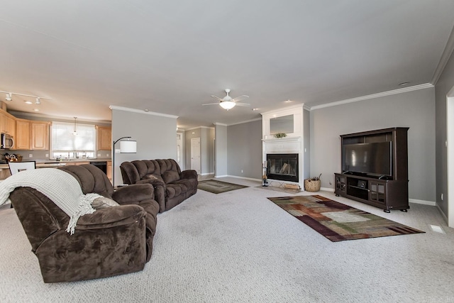 living room featuring ceiling fan, light colored carpet, and crown molding