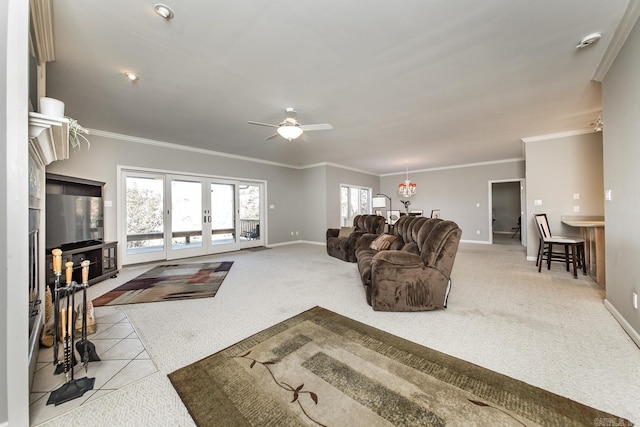 carpeted living room with french doors, ceiling fan, and ornamental molding