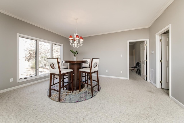 dining room featuring light carpet, a chandelier, and ornamental molding