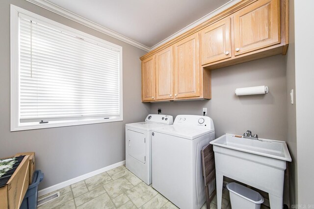 clothes washing area with cabinets, separate washer and dryer, crown molding, and sink