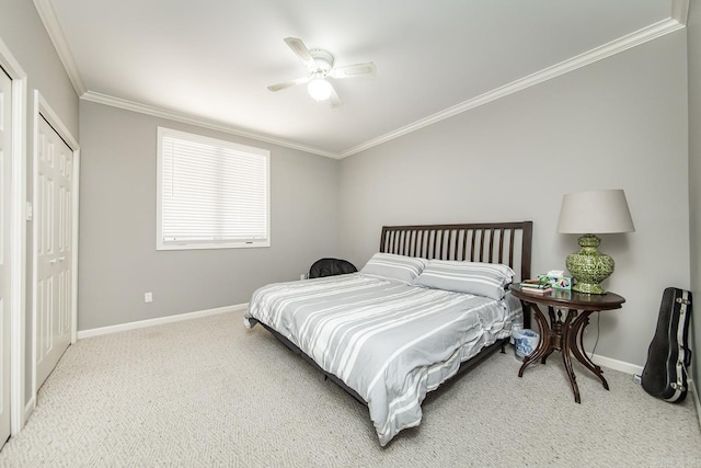 bedroom featuring carpet, ceiling fan, crown molding, and a closet