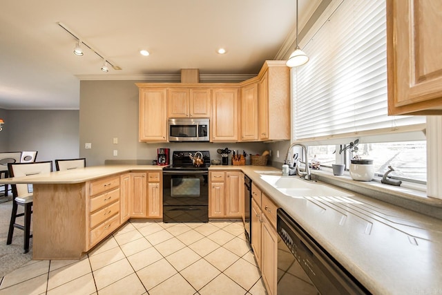 kitchen featuring black appliances, decorative light fixtures, light brown cabinets, and a kitchen bar