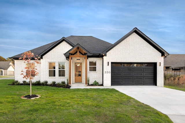 view of front of property with a front yard and a garage