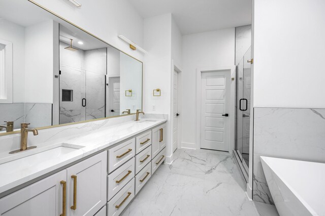 bathroom with vanity and independent shower and bath