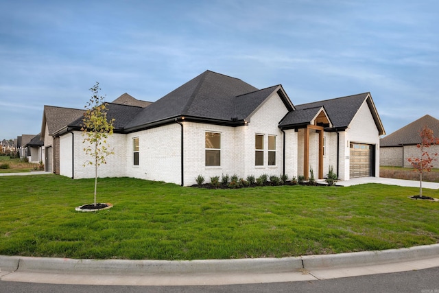 french provincial home featuring a garage and a front lawn