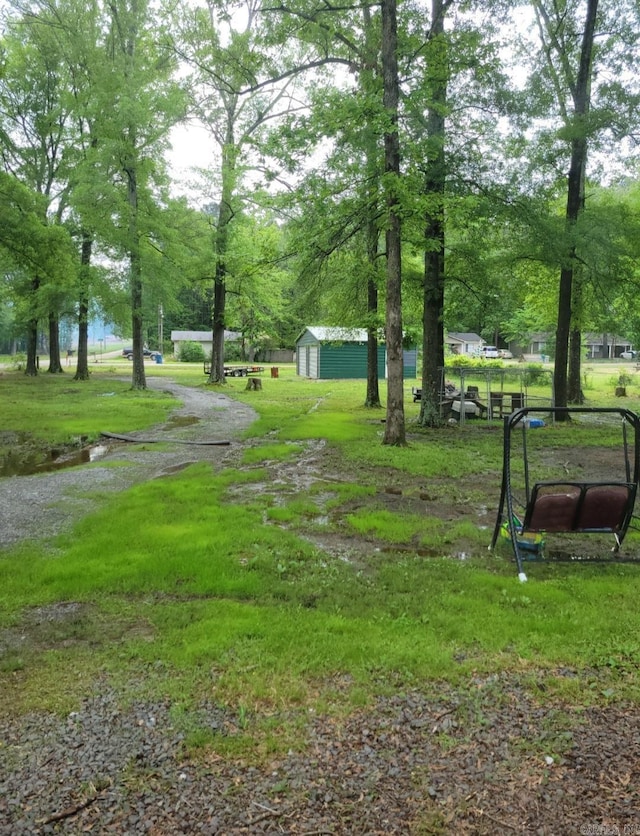 view of community featuring an outbuilding and a lawn