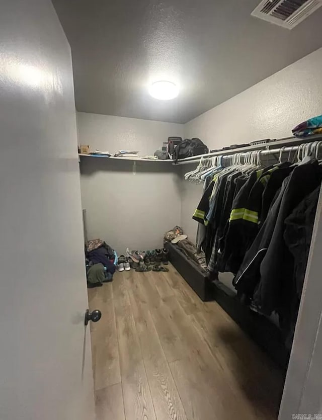 spacious closet featuring hardwood / wood-style flooring