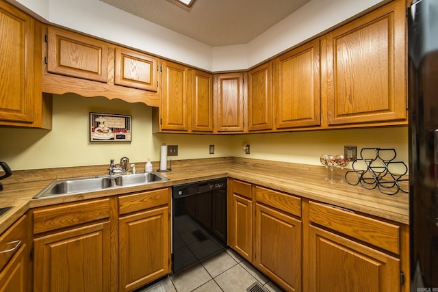 kitchen featuring dishwasher, light tile patterned floors, sink, and fridge