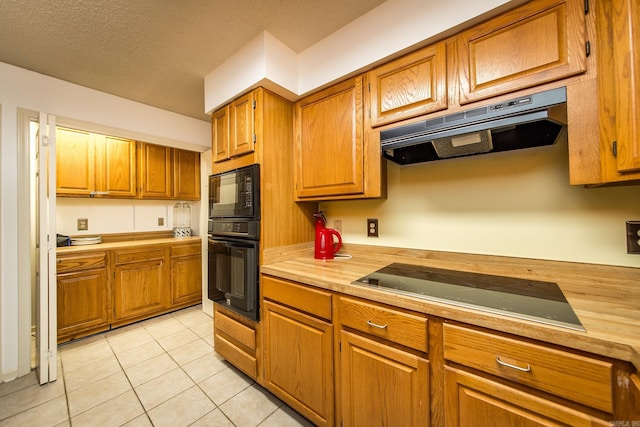 kitchen featuring light tile patterned floors and black appliances