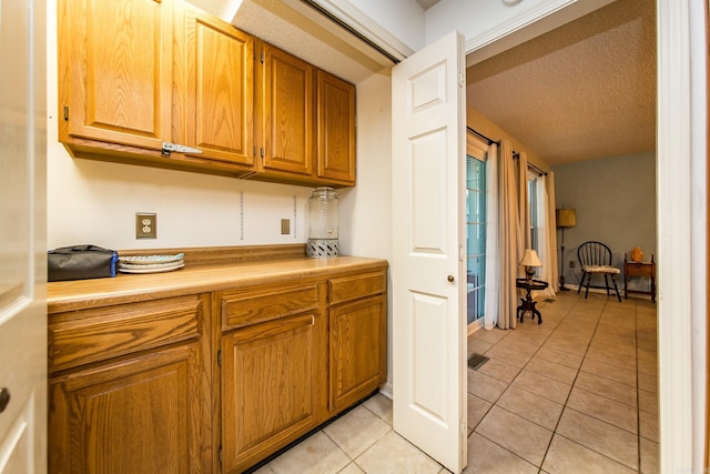 kitchen featuring light tile patterned floors and a textured ceiling