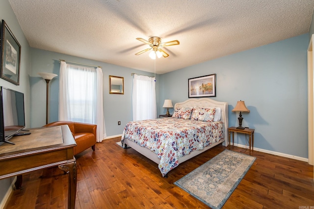 bedroom featuring a textured ceiling, ceiling fan, and dark wood-type flooring