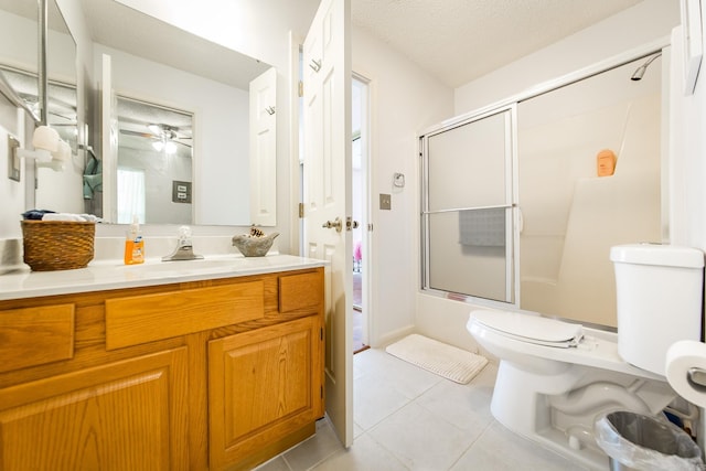 full bathroom featuring vanity, shower / bath combination with glass door, tile patterned floors, ceiling fan, and a textured ceiling