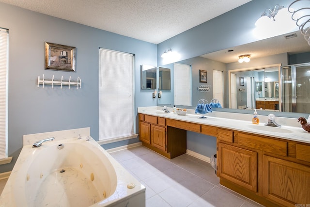 bathroom featuring tile patterned floors, plus walk in shower, vanity, and a textured ceiling