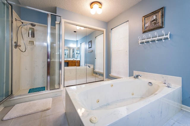 bathroom featuring tile patterned flooring, vanity, a textured ceiling, and shower with separate bathtub