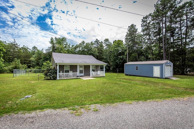 view of front of house with an outbuilding, a front lawn, and a porch