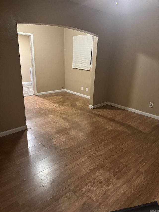 unfurnished room with dark hardwood / wood-style floors