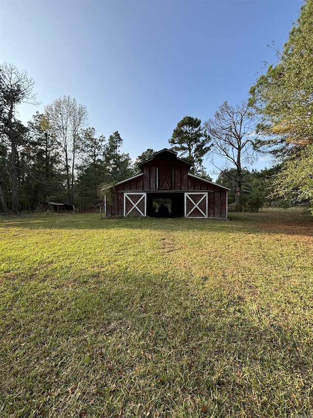 view of outbuilding featuring a lawn