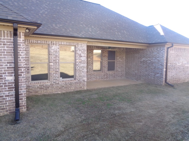 view of side of property with a lawn