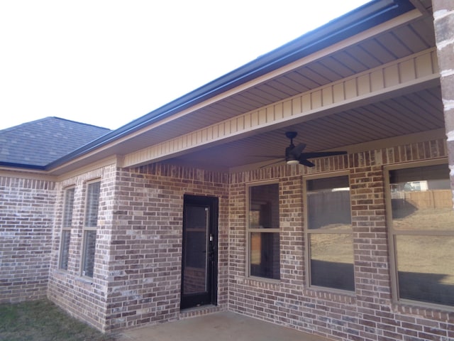 entrance to property with a patio area and ceiling fan