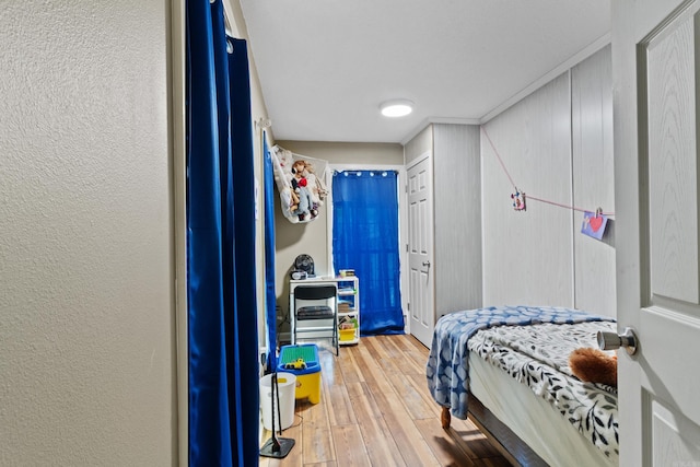 bedroom featuring hardwood / wood-style flooring and crown molding