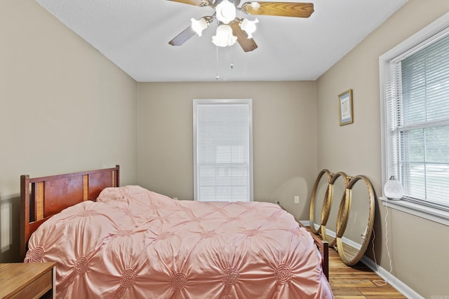 bedroom featuring light hardwood / wood-style floors and ceiling fan