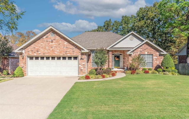 view of front of house with a front yard and a garage