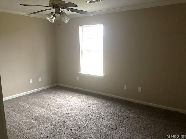 carpeted spare room featuring ceiling fan and crown molding