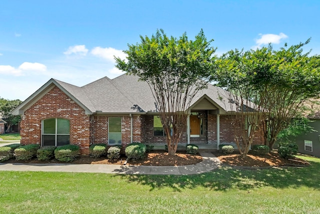 view of front facade with a front yard and covered porch