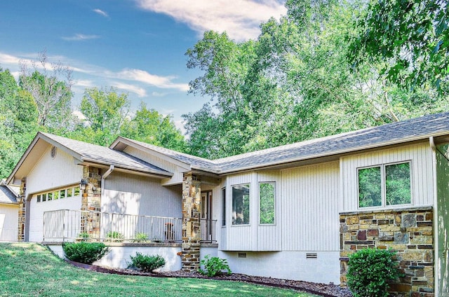 ranch-style house with a front yard, a porch, and a garage