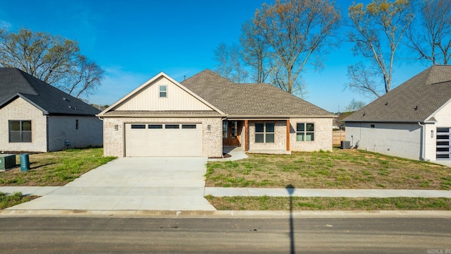 view of front of house featuring a front lawn, central AC unit, and a garage