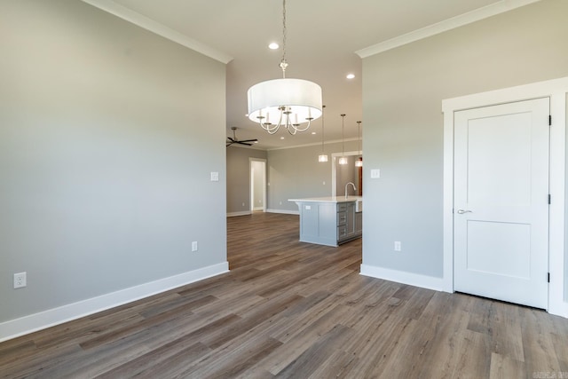 interior space with crown molding, hardwood / wood-style floors, and ceiling fan with notable chandelier