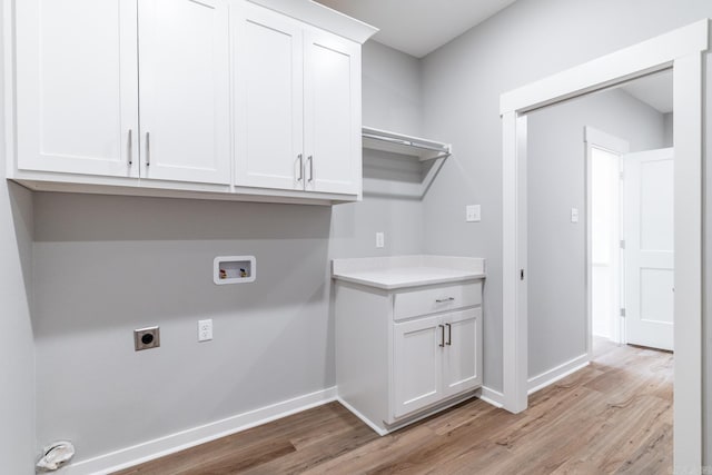 laundry room featuring hookup for a washing machine, light hardwood / wood-style flooring, cabinets, and hookup for an electric dryer