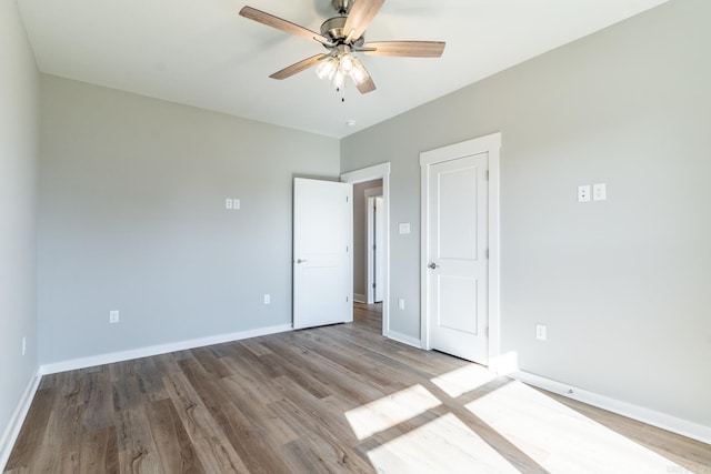 unfurnished bedroom featuring light wood-type flooring and ceiling fan