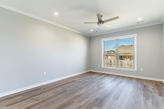 spare room featuring light hardwood / wood-style flooring, ceiling fan, and ornamental molding