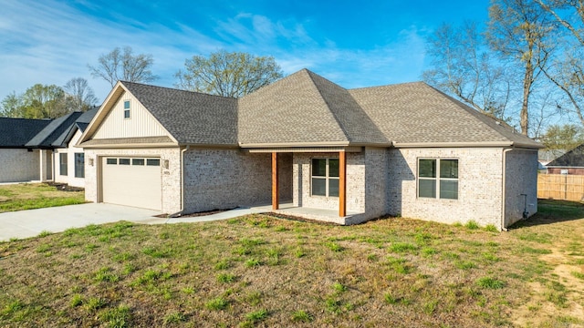 view of front of home with a front yard and a garage