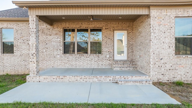 entrance to property featuring a patio and ceiling fan