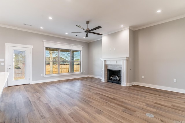 unfurnished living room featuring light wood-type flooring, ceiling fan, and ornamental molding