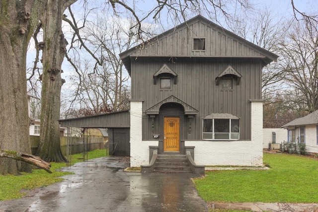 view of front facade with a front lawn and a carport