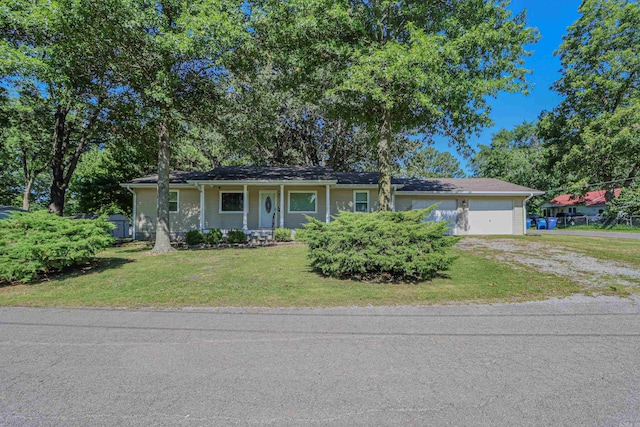 ranch-style home featuring a porch, a garage, and a front lawn