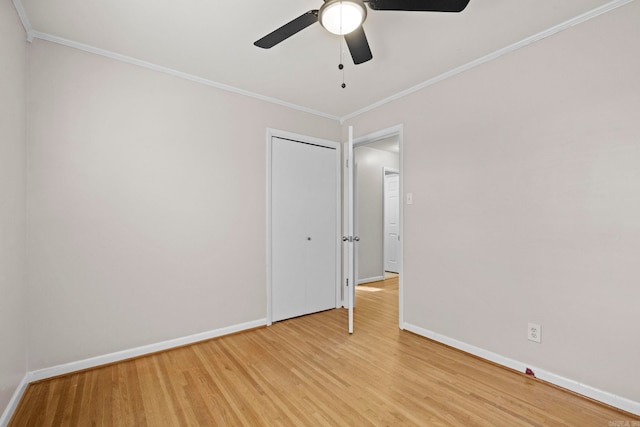 spare room featuring crown molding, ceiling fan, and light hardwood / wood-style floors