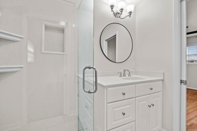 bathroom featuring hardwood / wood-style floors, vanity, and an enclosed shower