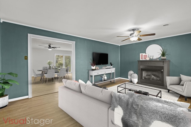 living room with ceiling fan, crown molding, and hardwood / wood-style flooring