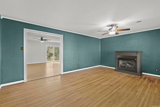 unfurnished living room featuring hardwood / wood-style flooring and crown molding