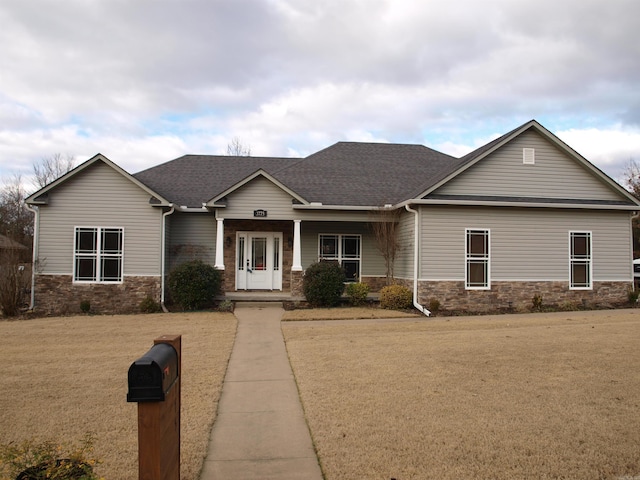 craftsman-style home with a porch and a front yard