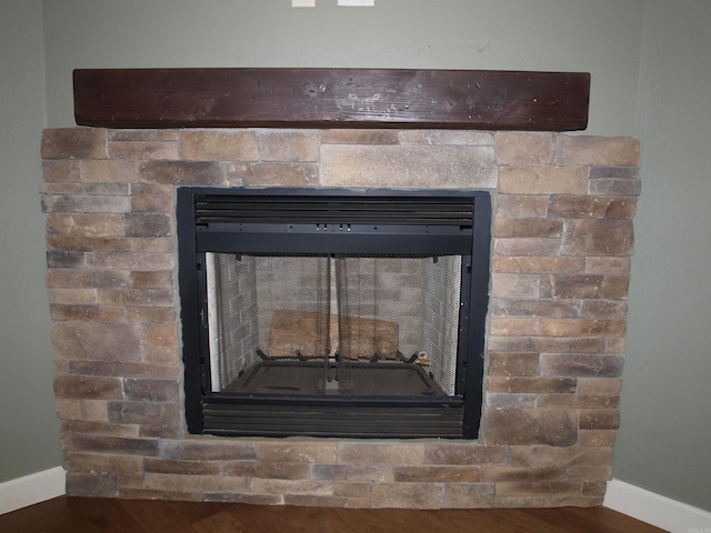 room details featuring a fireplace and wood-type flooring