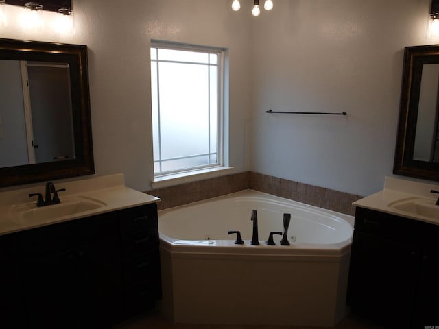 bathroom with a bathing tub and vanity