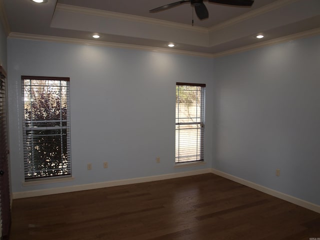 unfurnished room with dark hardwood / wood-style floors, a raised ceiling, ceiling fan, and crown molding